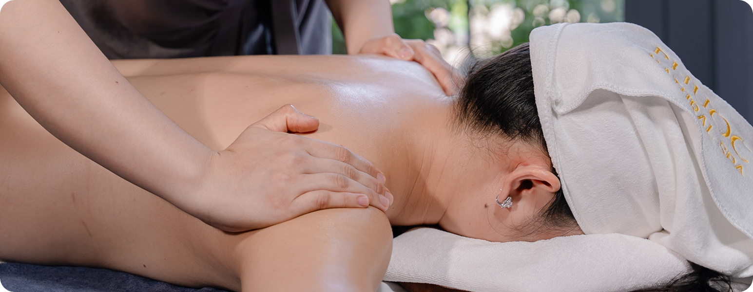 herapist performing a signature full body relaxation massage with organic pomelo oil at Phước Natural Spa in Hoi An